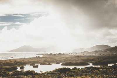 Scenic view of mountains against cloudy sky