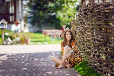 Happy young woman enjoying a sunny day outdoors in backyard