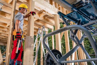 Low angle view of man working at construction site