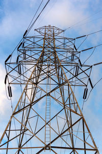 Low angle view of electricity pylon against sky