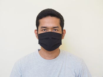 Portrait of young man against white background