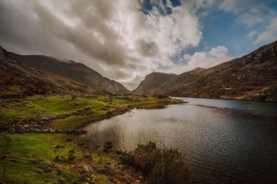 Scenic view of lake and mountains against sky