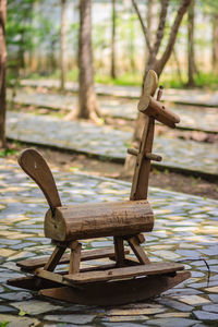 Close-up of empty chair on table by lake