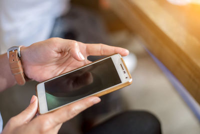 Midsection of man using mobile phone