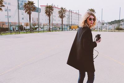 Portrait of a woman standing on road