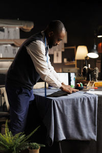 Side view of man working at market stall