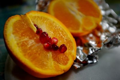 Close-up of pomegranate seeds on orange