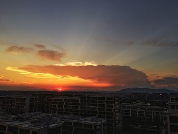 Cityscape against sky during sunset