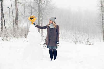 Man standing on snow covered land