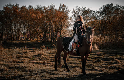 Full length of woman sitting on horse