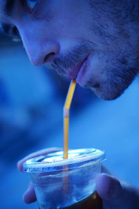 Close-up of man drinking glass