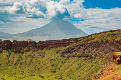 View of shimo la mungu - pit of god with mount ol doinyo lengai in the background, tanzania