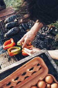 High angle view of man preparing food on barbecue grill