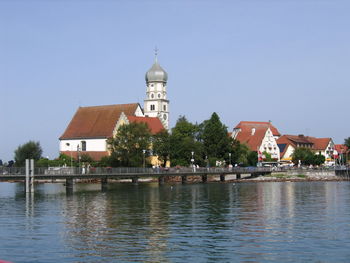 Canal amidst buildings against sky