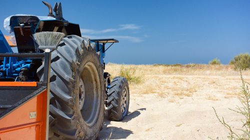 Tractor on field against sky