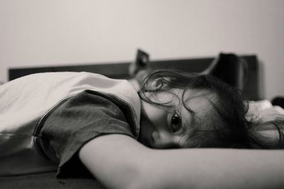 Portrait of boy lying on bed at home