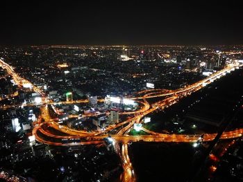 Aerial view of illuminated city against sky at night