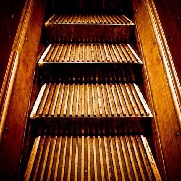 indoors, wood - material, low angle view, no people, architecture, built structure, steps, house, full frame, pattern, in a row, high angle view, staircase, repetition, close-up, steps and staircases, backgrounds, wood, wooden, railing