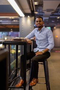 Portrait of young man sitting on chair