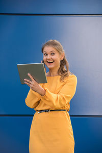Portrait of smiling young woman using smart phone
