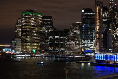 Illuminated buildings against sky at night