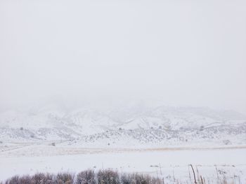 Snow covered landscape against sky