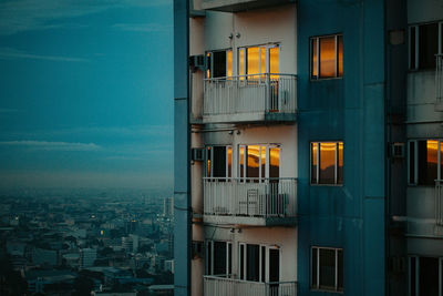 Buildings against sky seen through glass window