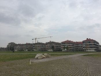 Buildings against cloudy sky