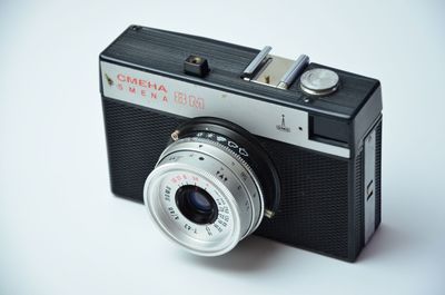 Close-up of camera over white background