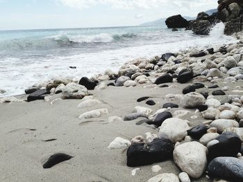 Rocks on beach against sky