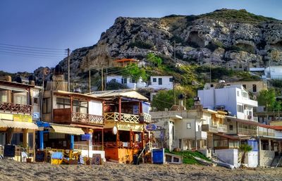 Houses by mountains against clear sky