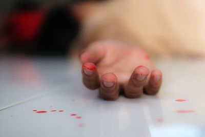 Cropped hand of woman on floor