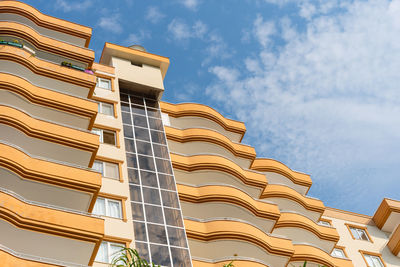 Low angle view of an apartment building with balconies. residential real estate.