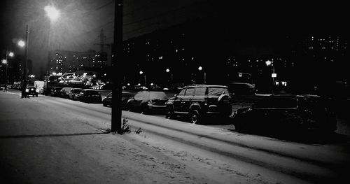 Illuminated city street during winter at night