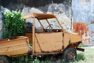 Abandoned truck against wall