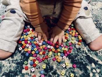 Low section of women sitting on multi colored hands