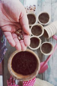 Cropped hand planting seeds