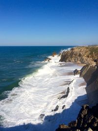 Scenic view of sea against blue sky