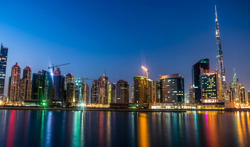 Low angle view of skyscrapers lit up at night