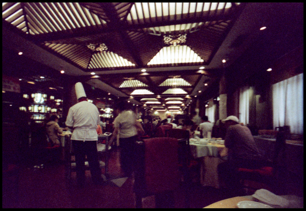 REAR VIEW OF PEOPLE AT RESTAURANT