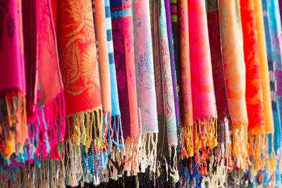 Many colorful fabric are hanging on the clothesline.