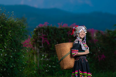 Woman wearing hat standing on field