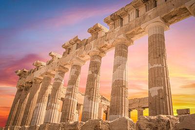 Low angle view of old ruin against sky during sunset
