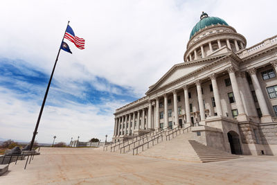 Low angle view of flags against sky