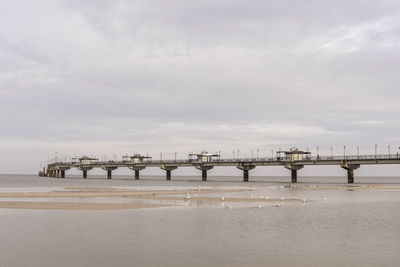 Pier over sea against sky