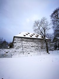 Low angle view of house against sky during winter