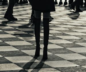 Low section of people walking on zebra crossing