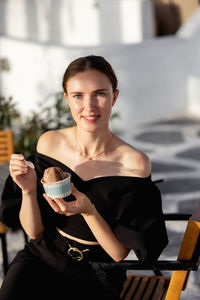 Portrait of young woman drinking glass