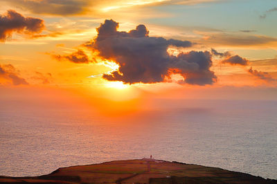 Scenic view of sea against romantic sky at sunset