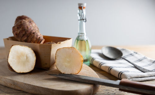 Close-up of bread and cutting board on table